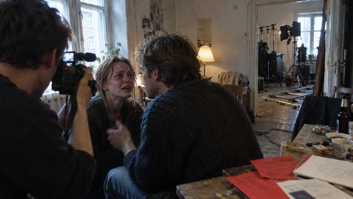 1990s independent film crew shooting a raw handheld scene on location under natural light in the spirit of the Dogme 95 rules