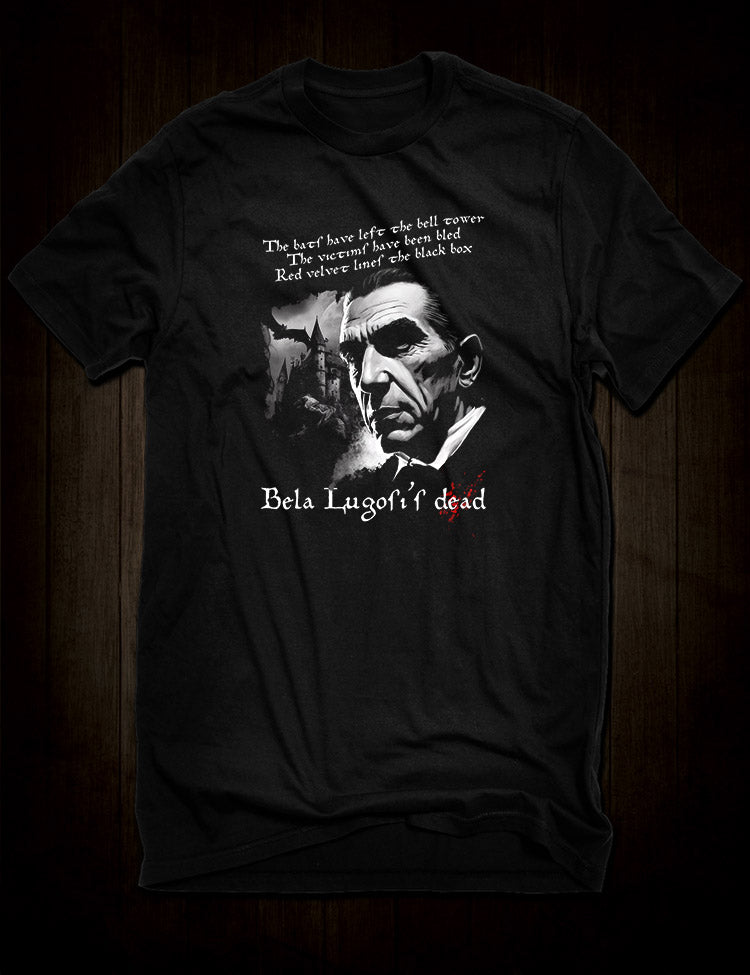 A vintage-style t-shirt featuring a distressed graphic of Bela Lugosi himself, along with the iconic lyrics to "Bela Lugosi's Dead" in a spooky font.